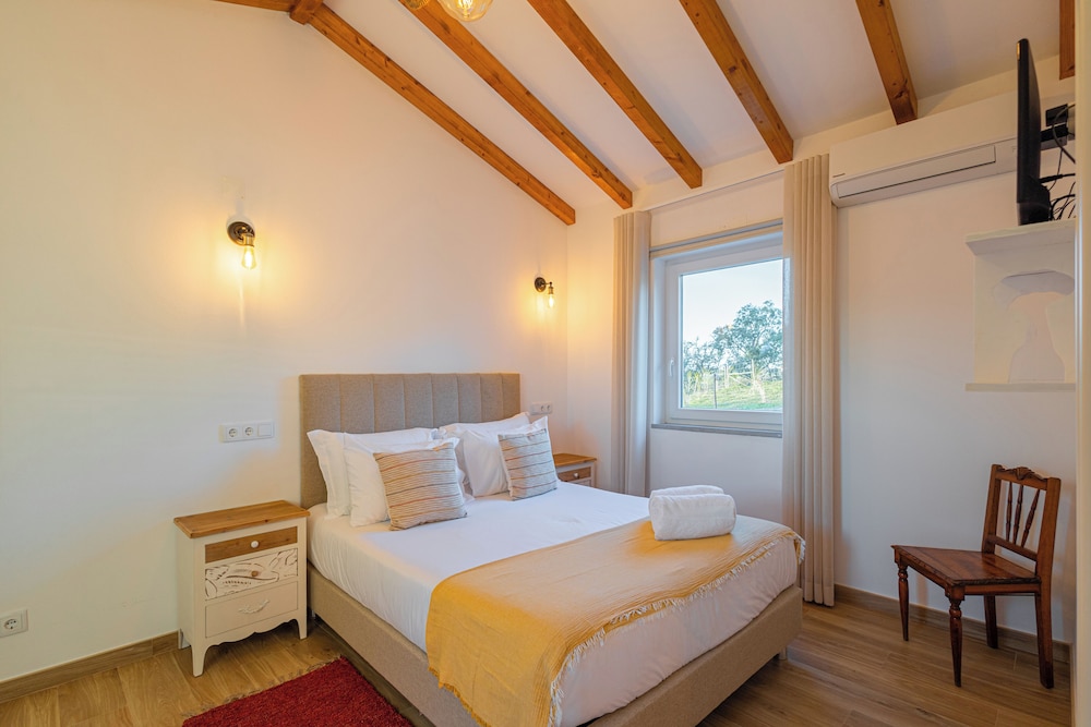 Slaapkamer in Monte Do Cerro met rustieke bedden en stenen muren